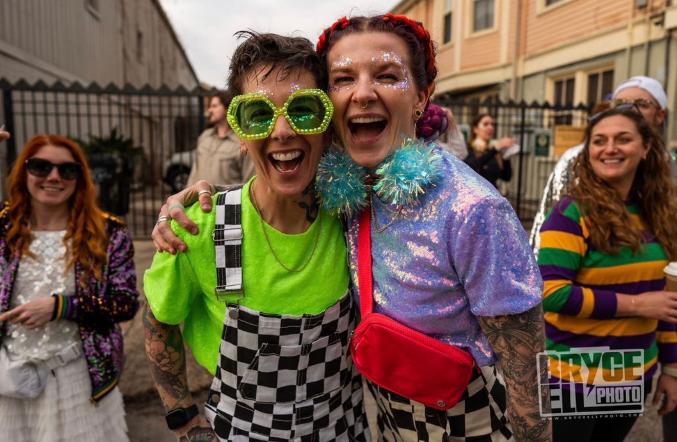 Kelly and Zoomz in glitter and Mardi Gras costumes on a New Orleans street